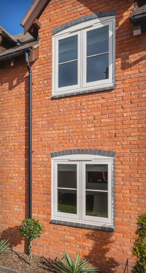 Close up of Chartwell Green casement windows on red bricked wall