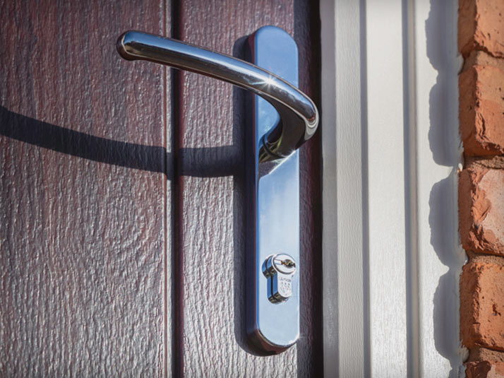 Dark Wood Composite Door and a Silver Handle