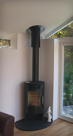 Modern log burner fireplace in the corner of a conservatory